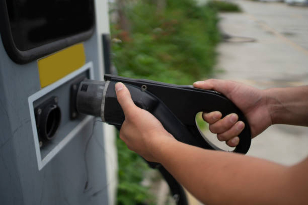istock Men use electric vehicle charging station system, modern automobile technology, clean energy or environmental protection concept 1403167238