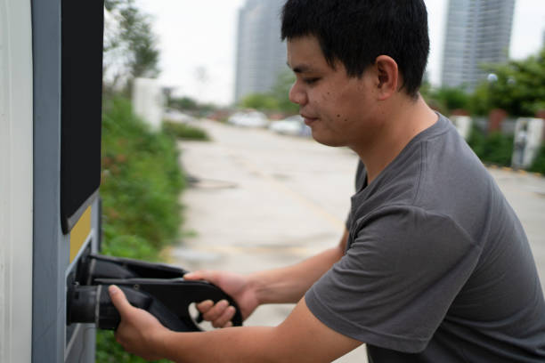 istock Men use electric vehicle charging station system, modern automobile technology, clean energy or environmental protection concept 1403167242