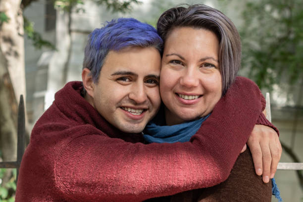 istock Two smiling friends are hugging and looking at camera. 1403169910