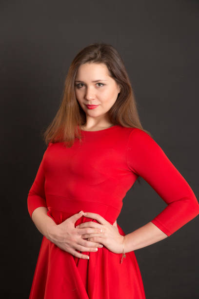 studio portrait of a young girl in a red dress