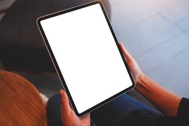 istock Mockup image of a woman holding digital tablet with blank white desktop screen 1403171596