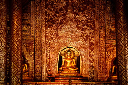 The beauty of Buddha images, Thai patterns and Thai interiors in the hall at Wat Phra Singh, Chiang Mai, Thailand.