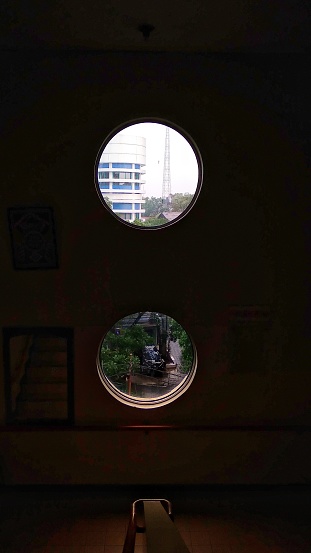 Observing city life in a small circular window.