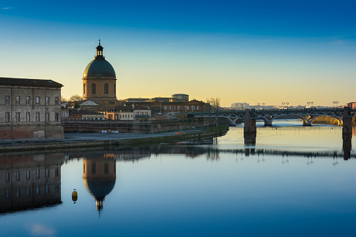 Bridge and architecture of Toulouse city in France at sunset