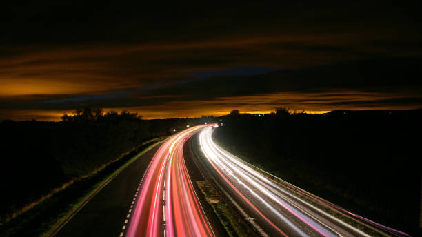 istock Rush hour fast car moving night city ,Fast moving traffic drives moving fast light each effect line light cg time lapse 1403178145