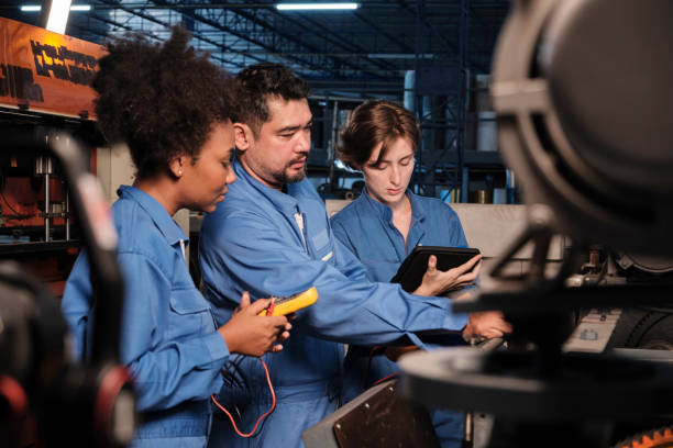 Engineer teams inspect machines' electric current at the industry factory stock photo
