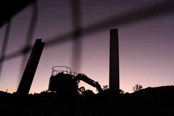 Silhouette Of Excavator Against Sky During Sunset