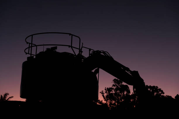 Silhouette Of Excavation / Earthmoving Equipment At Dusk On Construction Site