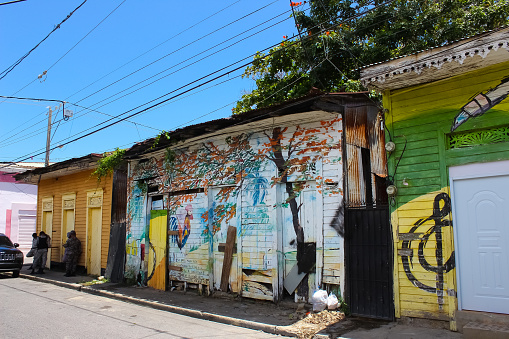 Puerto Plata, DR - May 04, 2022: Shops and painting near buildings in the center of Puerto Plata, Dominican Republic