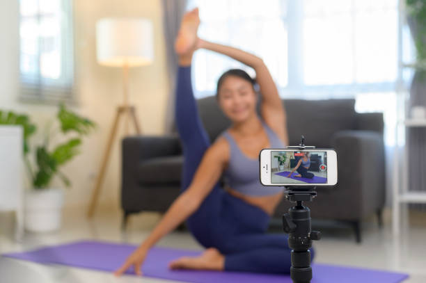 istock Professional yoga coach teaching online training class to students during live streaming on social media, healthcare concept 1403188759