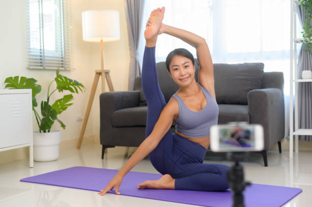 istock Professional yoga coach teaching online training class to students during live streaming on social media, healthcare concept 1403188767