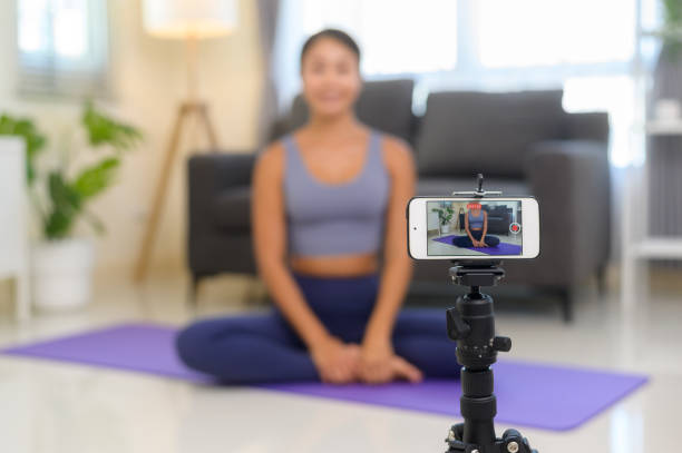 istock Professional yoga coach teaching online training class to students during live streaming on social media, healthcare concept 1403188768