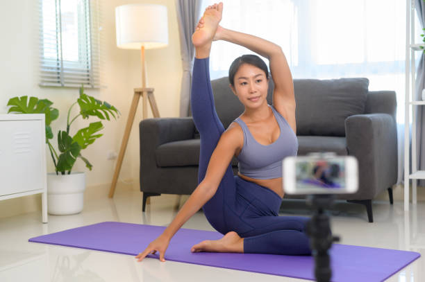 istock Professional yoga coach teaching online training class to students during live streaming on social media, healthcare concept 1403188772