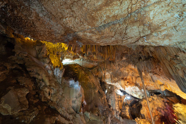 istock Natural stalactite and stalagmite rock stone cliff hang from cave ceiling in cave. Environmental explore. Landscape background. Erosion 1403189217