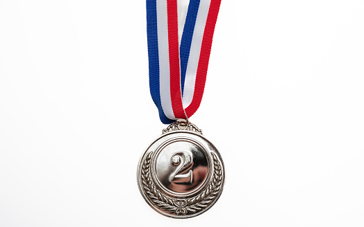 Silver medal, second place. Champion trophy award and red blue ribbon, design element. Prize in sport isolated cutout on white background