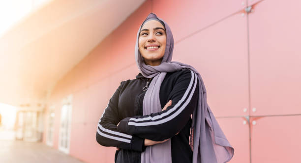 portrait of attractive muslim sporty woman with hijab outdoors portrait of attractive muslim sporty woman with hijab outdoors modest clothing stock pictures, royalty-free photos & images