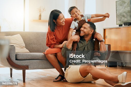 istock A happy mixed race family of three relaxing in the lounge and being playful together. Loving black family bonding with their son while playing fun games on the sofa at home 1403196779