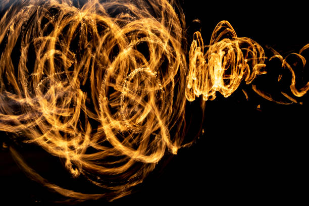 istock Flames on long hatchet. Traces of fire in dark. 1403196855