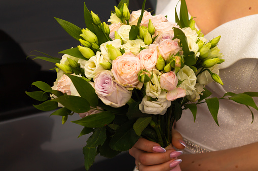 Beautiful wedding bouquet. The bride is holding a bouquet in her hands. Bride's flowers.