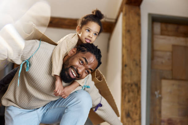 istock Single black father having fun with his little daughter at home. 1403198326