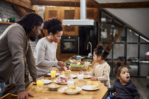 istock Young black family enjoying in breakfast in the kitchen. 1403198588