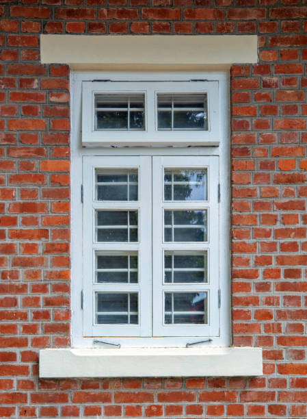 istock Wooden windows on vintage red brick house. 1403200879