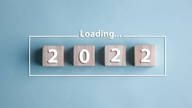 istock Wood block in loading bar for 2022 start new year. 1403201159