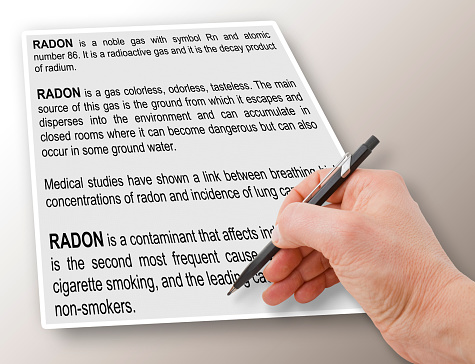 Hand writing a definition and explanation of natural dangerous Radon Gas - concept image.