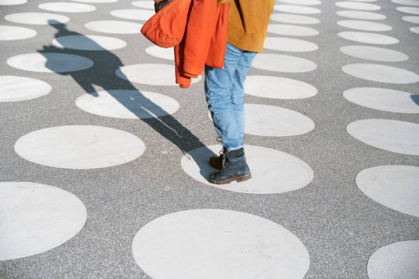 istock young  woman standing on white circle at spotted town square 1403202581