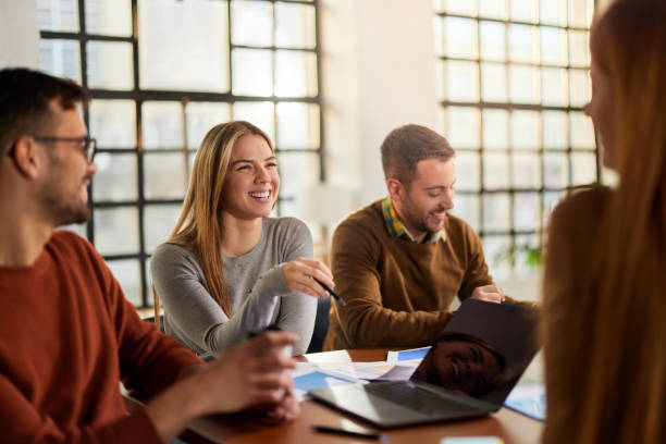 istock Happy creative team talking while having a meeting in the office. 1403203879