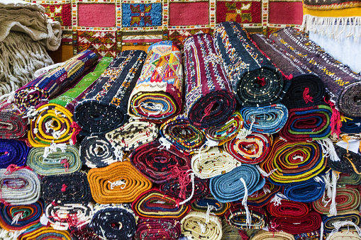 Stack of colorful, traditional Peruvian fabrics. Tourist's market in Chinchero village, Sacred Valley, Peru.The Sacred Valley of the Incas or Urubamba Valley is a valley in the Andes  of Peru, close to the Inca capital of Cusco and below the ancient sacred city of Machu Picchu. The valley is generally understood to include everything between Pisac  and Ollantaytambo, parallel to the Urubamba River, or Vilcanota River or Wilcamayu, as this Sacred river is called when passing through the valley. It is fed by numerous rivers which descend through adjoining valleys and gorges, and contains numerous archaeological remains and villages. The valley was appreciated by the Incas due to its special geographical and climatic qualities. It was one of the empire's main points for the extraction of natural wealth, and the best place for maize production in Peru.http://bem.2be.pl/IS/bolivia_380.jpg