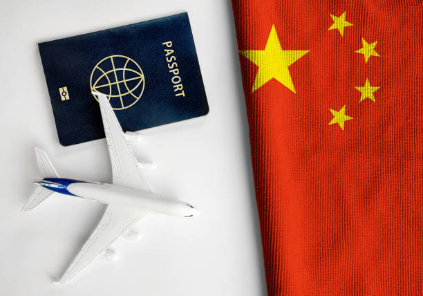 Flag of China with passport and toy airplane. stock photo