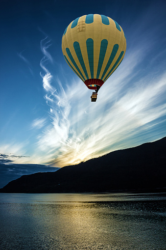 Hot air balloon over sea, Geiranger, Norway. Sunrise, Norwegian cruise