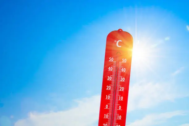 Photo of thermometer in front of the sun to represent global warming