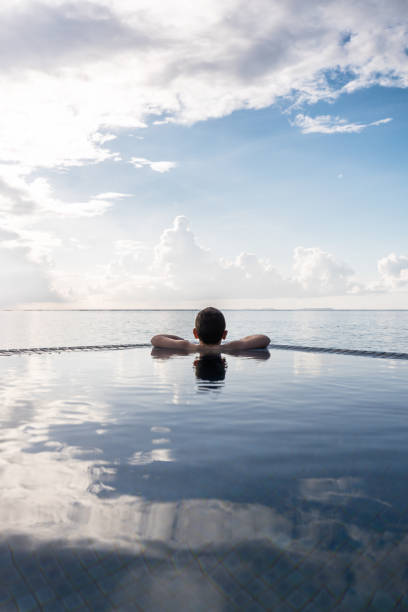 istock Little kid looking the ocean from a infinity pool 1403215661