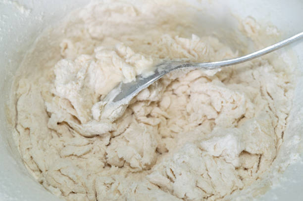 abstract background with kneading the dough in a bowl with a spoon. Selective focus