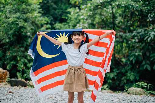 Young Girl Celebrating Malaysia Independence Day beside a river