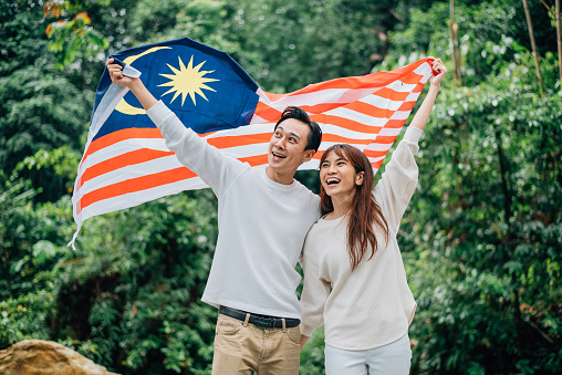 Couple Celebrating Malaysia Independence Day in a jungle
