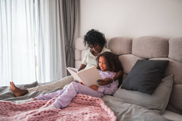 istock Caring Mother Reading A Book To Her Daughter 1403217560