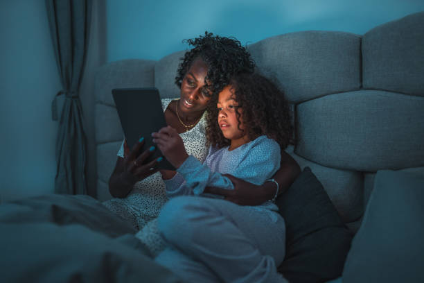 istock Mother And Daughter Using A Digital Tablet Before Going To Sleep 1403217587