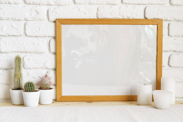 istock Square wooden photo frame and cactus plants on the table 1403217665