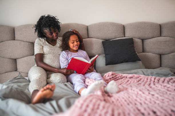 istock Expecting Black Mother Reading A Book To Her Mixed Race Daughter 1403217745