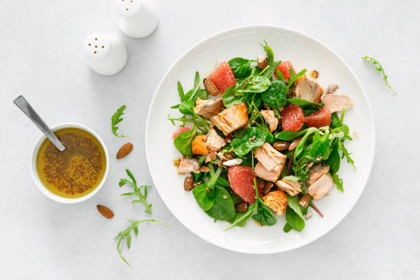 istock Grilled salmon salad with grapefruit, almonds and salad mix. Top view 1403220642