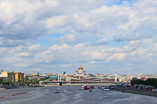 Cityscape with historical architecture on the embankment of the Moscow river and tourist boats and a clear sunny summer day