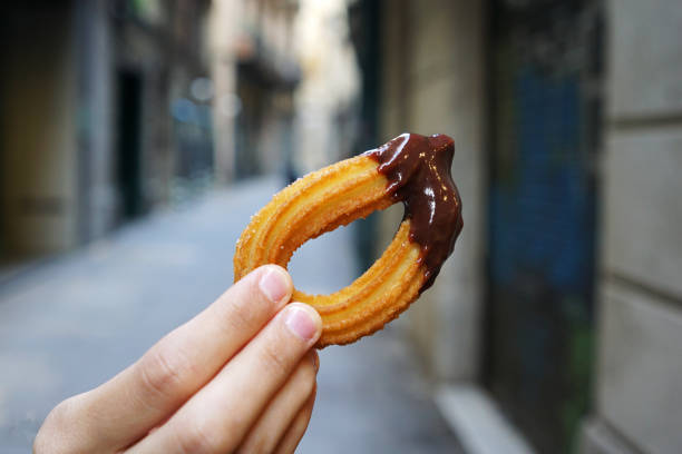 istock Hand dipping traditional Churros with hot chocolate 1403222695