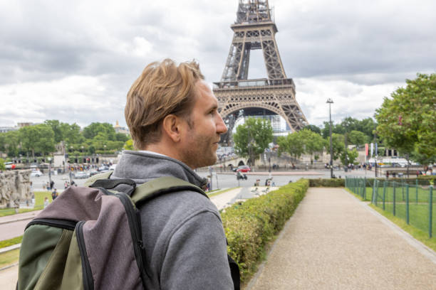istock Young man in Paris walking near the Eiffel Tower 1403224482