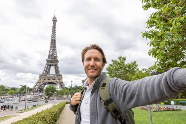 istock Young man taking selfie in Paris at the Eiffel Tower 1403225784