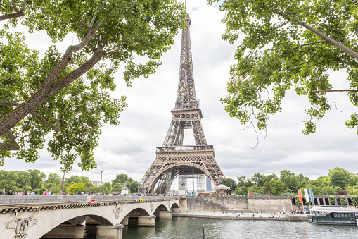 Paris, France - December 29, 2023:  Pont Rouelle with Eiffel Tower in the background as viewed from a Seine River cruise boat on a cloudy day.  HDR encoded