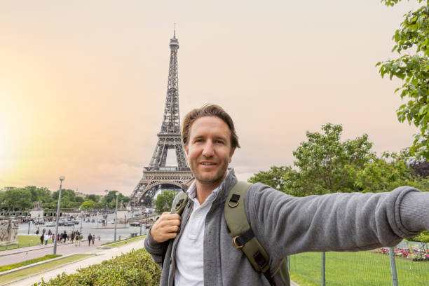 istock Young man taking selfie in Paris at the Eiffel Tower 1403226676