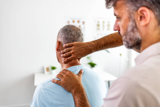 istock Man suffering from back pain during medical exam 1403226731